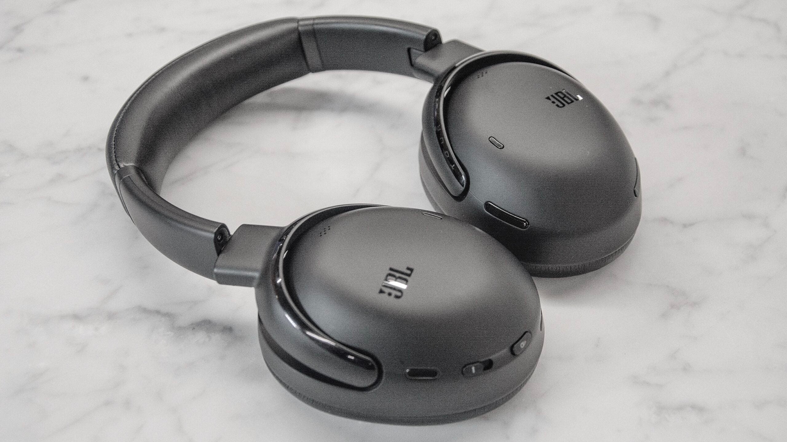 The JBL Tour ONE M3 shown, earcups facing down